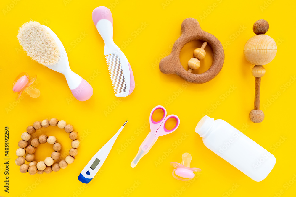 Set for children's hygiene on a yellow background, top view, flat lay. Means to care for a newborn. Trendy baby concept, bright background Set for children's hygiene on a yellow background, top view, flat lay. Means to care for a newborn. Trendy baby concept, bright background