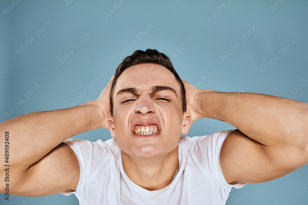 Man gestures with his hands emotions white t-shirt expression blue background Man gestures with his hands emotions white t-shirt expression blue background