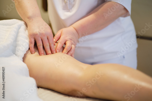 Body care concept. Special anticellulite treatment. Masseur makes anticellulite massage young woman in spa salon. Close up view