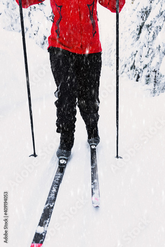 Cross-country skiing. Person in motion through a skiing slope in a winter wonderland on a bright sunny day. photo