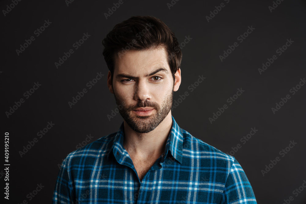 Thinking handsome unshaven guy posing and looking at camera Thinking handsome unshaven guy posing and looking at camera