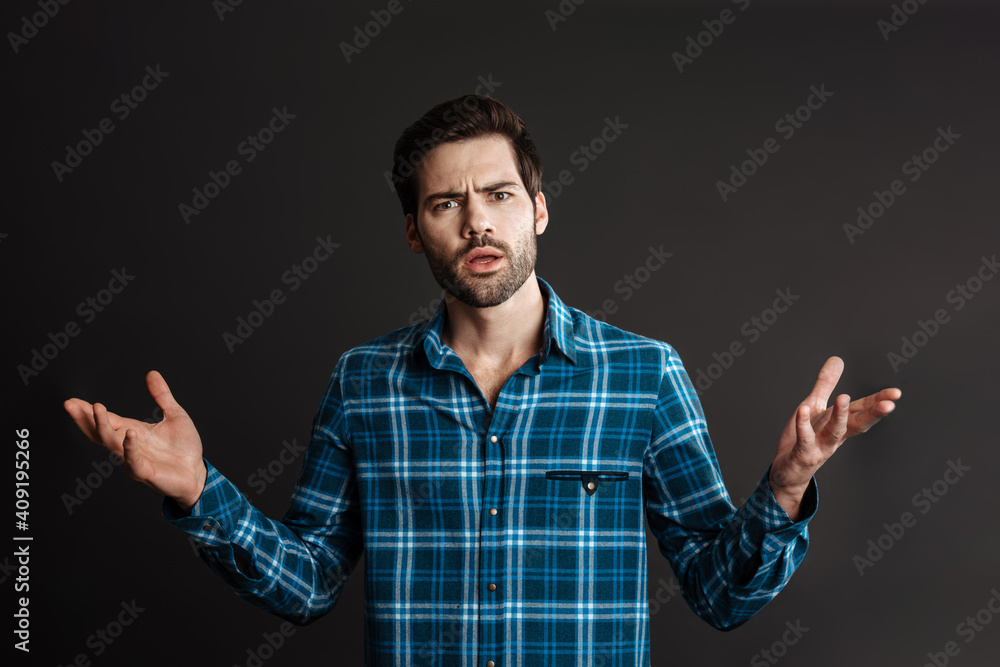 Confused handsome unshaven guy posing with hands up Confused handsome unshaven guy posing with hands up
