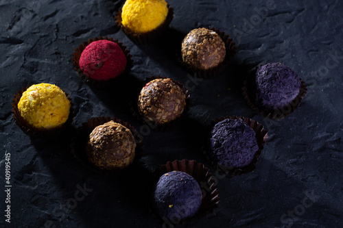 Colored round candies on a dark background