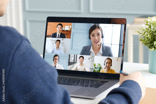Tableau sur toile Young Asian businessman work at home and virtual video conference meeting with c