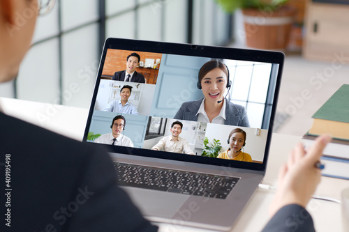 Obraz na plátne Young Asian businessman work at home and virtual video conference meeting with c
