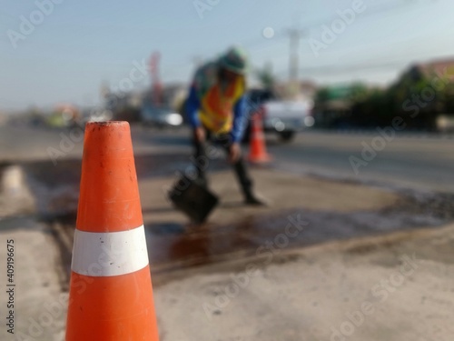 Road construction blur And the rubber cone is located in front