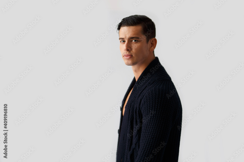 Profile portrait of handsome fit brunette young man in black sweater, isolated grey background. Profile portrait of handsome fit brunette young man in black sweater, isolated grey background.
