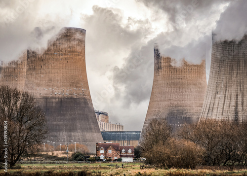 Coal fired power station cooling tower chimneys with house global warming action Nottinghamshire electric generator smoke and steam national grid photo