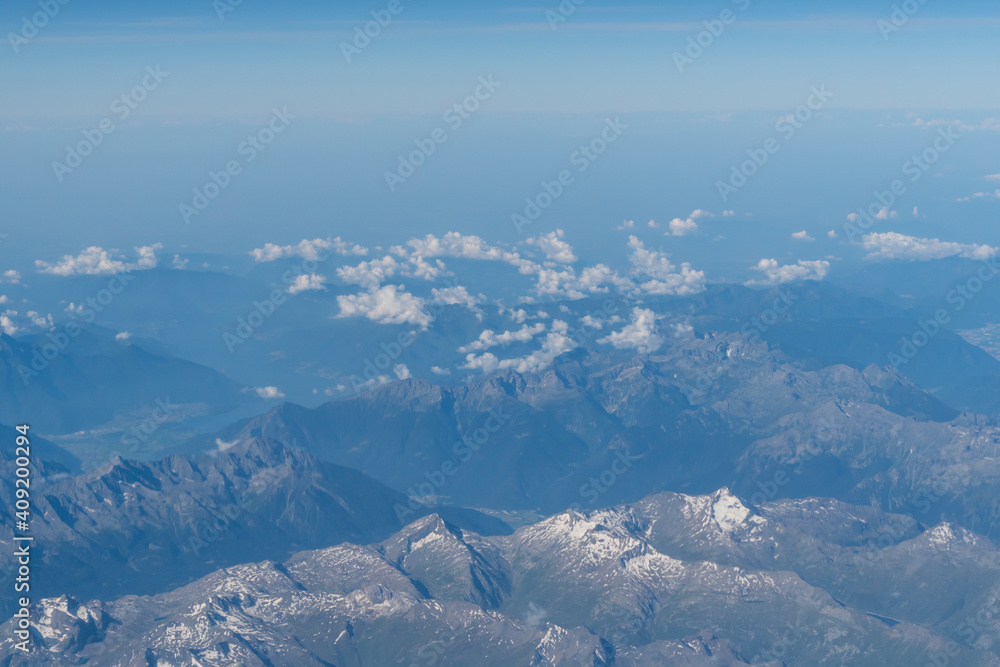 Fototapeta premium Beautiful View from airplane on the aircraft of the planet Earth cloudy landscape in sunny. Air travel and transportation concept.