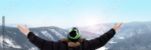 Man with arms raised, panorama, back view, background, copy space, winter day. Adventure, active rest, healthy lifestyle.
