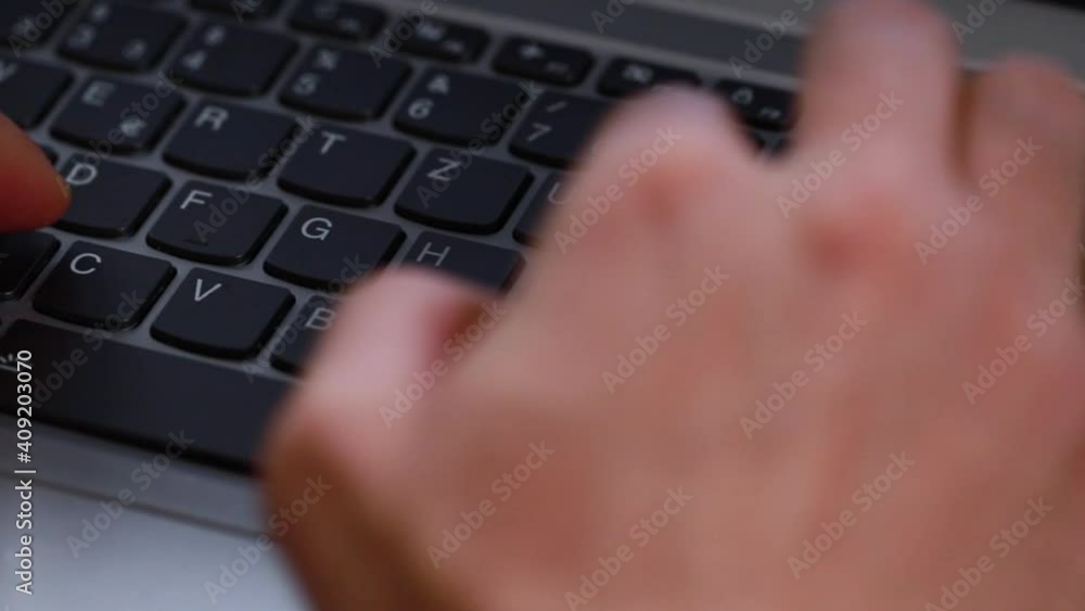 someone is typing on a modern computer keyboard someone is typing on a modern computer keyboard