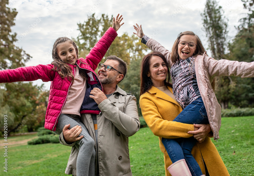 Portrait of family of four enjoying together in city park. Portrait of family of four enjoying together in city park.