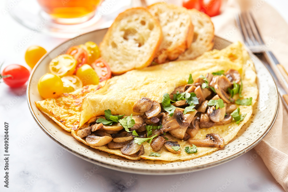 Omelet with champignons and parsley in plate on marble background. Frittata - italian omelet for breakfast or lunch. Omelet with champignons and parsley in plate on marble background. Frittata - italian omelet for breakfast or lunch.