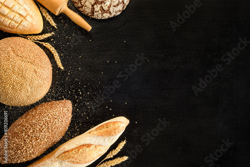 Different types of bread on a black background. Top view.