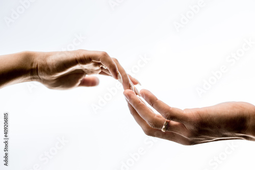 guy and a girl stretch out their hands to each other