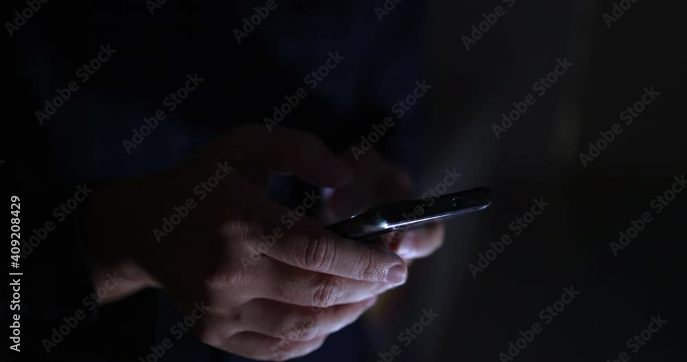 4K Video close up hand touch and text on mobile phone screen in the dark tone. Concept for mobile technology and lifestyle.