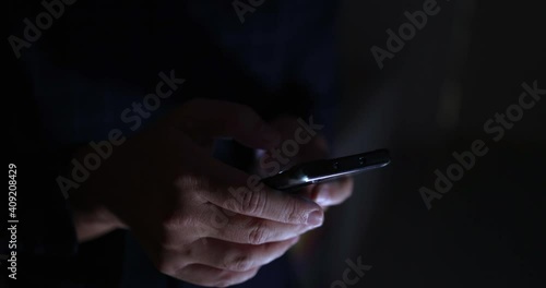 4K Video close up hand touch and text on mobile phone screen in the dark tone. Concept for mobile technology and lifestyle.