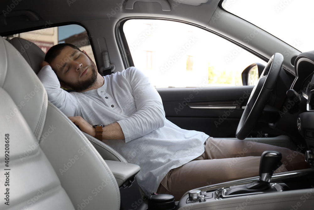 Tired man sleeping in his modern car Tired man sleeping in his modern car