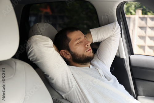 Tired man sleeping in his modern car