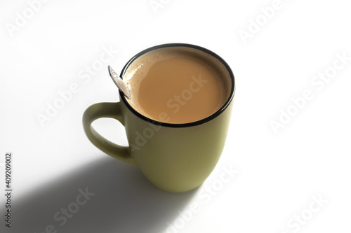 In the horizontal image on a white background in the center of the coffee with milk in a mug