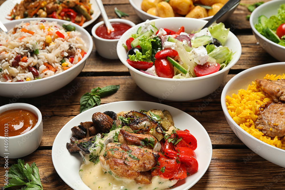 Buffet service. Many different dishes on wooden table Buffet service. Many different dishes on wooden table