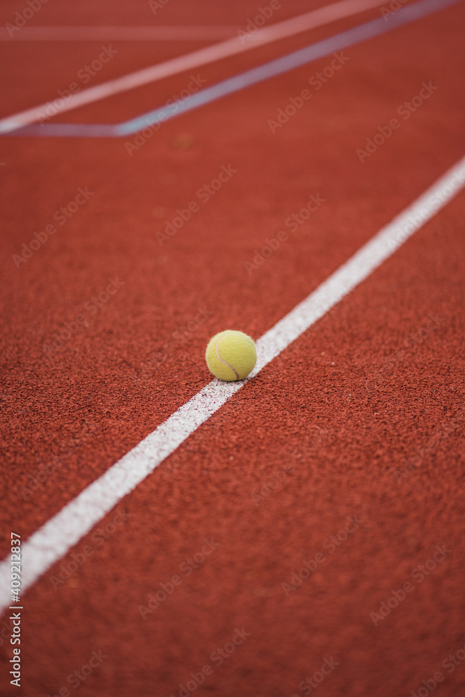 Tennis field and tennis ball on the flour 