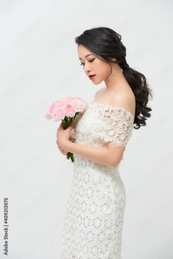 portrait of attractive asian woman wearing wedding dress isolated on white background portrait of attractive asian woman wearing wedding dress isolated on white background