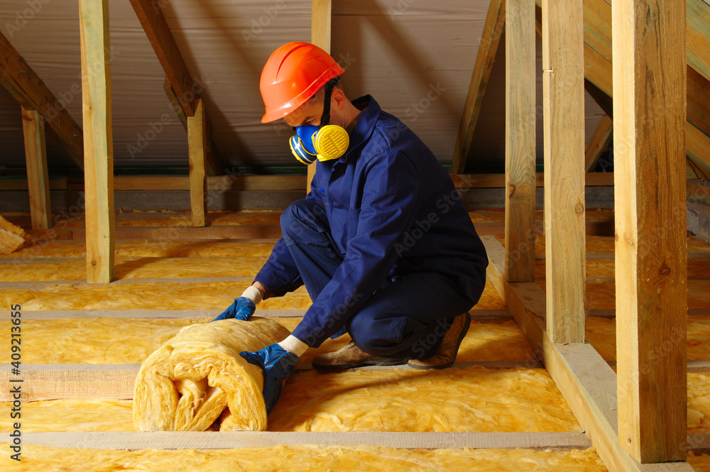 Man installing thermal roof insulation - obrazy, fototapety, plakaty 