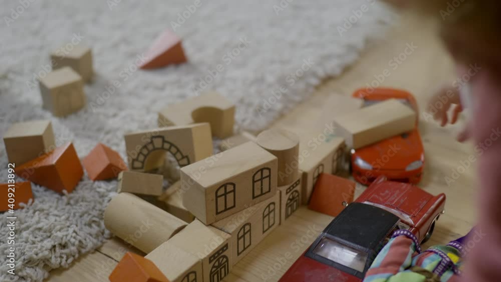 Baby plays with blocks, tries to build then destroyes block tower ...