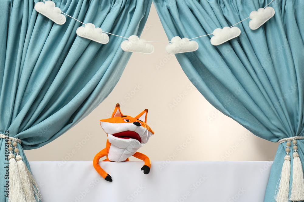 Naklejka premium Creative puppet show on white stage indoors