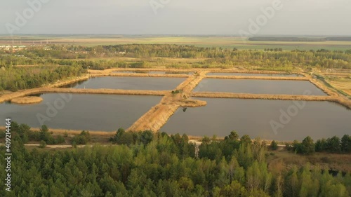 4K Cinematic Calm Flight Above Aerial View Retention Basins, Wet Pond, Detention Basin Or Stormwater Management Pond photo