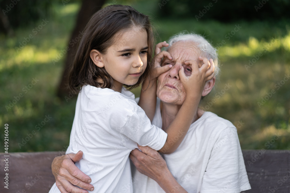 Affectionate granddaughter and grandmother are hugging. Happy together Affectionate granddaughter and grandmother are hugging. Happy together