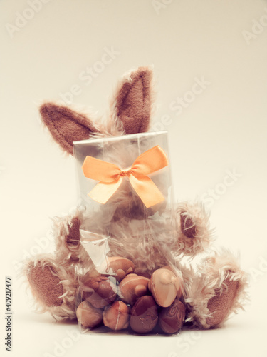 Easter bunny toy with bag of chocolates photo