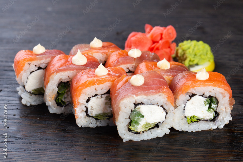 traditional Japanese sushi with salmon, avocado and soft cheese, garnished with red caviar. Japanese kitchen. Japanese restaurant. traditional Japanese sushi with salmon, avocado and soft cheese, garnished with red caviar. Japanese kitchen. Japanese restaurant.