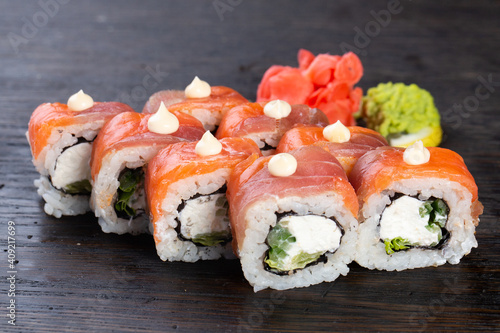 traditional Japanese sushi with salmon, avocado and soft cheese, garnished with red caviar. Japanese kitchen. Japanese restaurant.