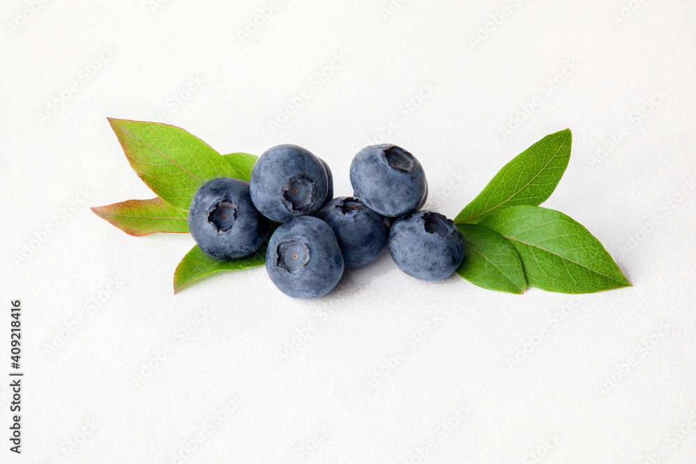 Blueberries with leaves on white background Blueberries with leaves on white background