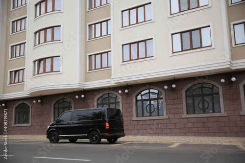 Black delivery van parked on street near building © New Africa