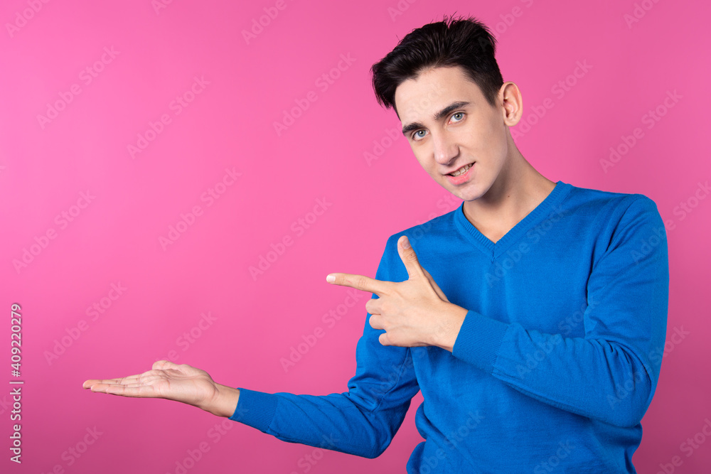 A young man gestures with his hands. Pink background. Consent and denial. Good and bad. A young man gestures with his hands. Pink background. Consent and denial. Good and bad.