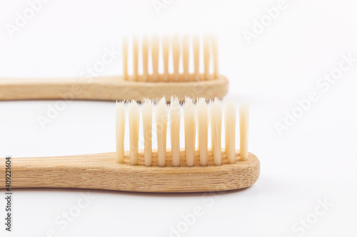 Two eco friendly bamboo toothbrushes isolated on white.