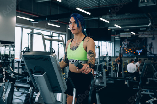 tattooed woman workout in gym