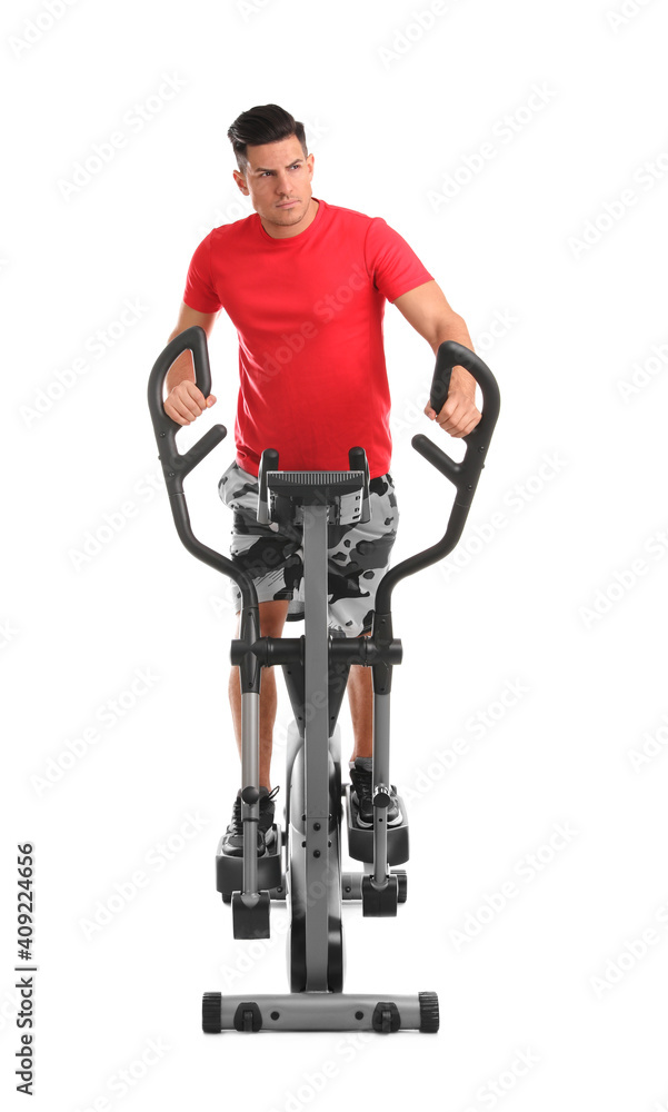 Man using modern elliptical machine on white background Man using modern elliptical machine on white background