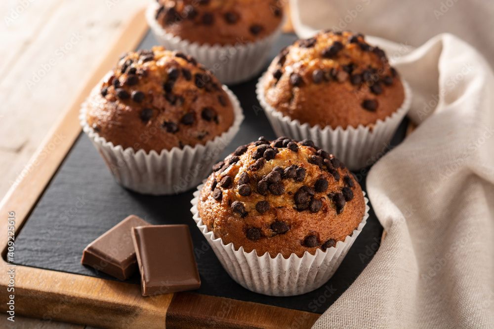 Just baked chocolate muffins on rustic wooden table Just baked chocolate muffins on rustic wooden table