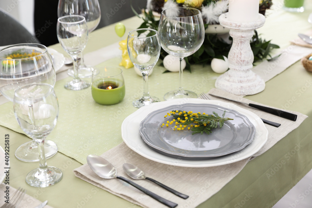 Beautiful Easter table setting with floral decor indoors