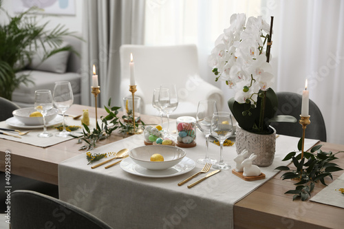Wall Mural Beautiful Easter table setting with white orchid flowers indoors
