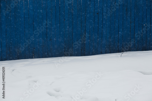 Blue fence and snow. 