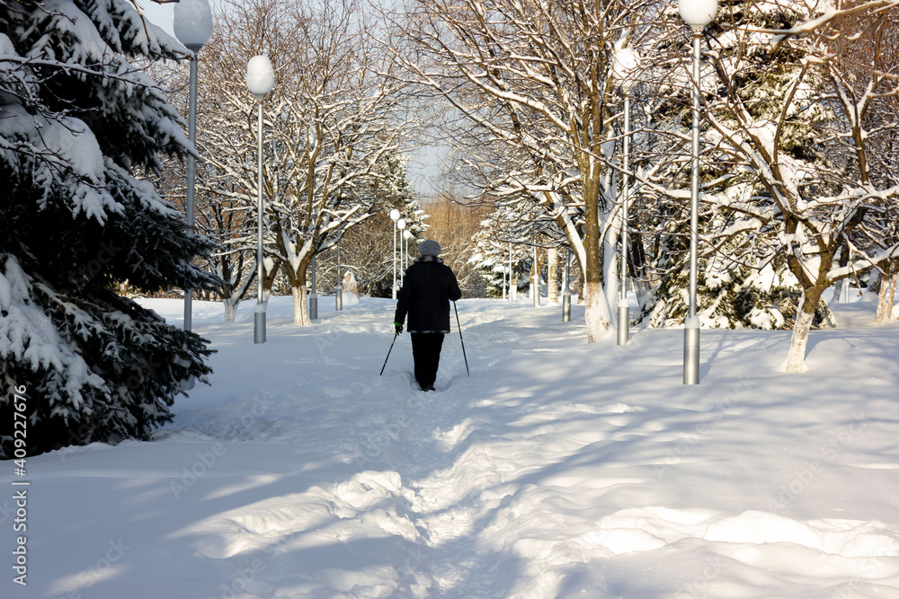 Senior at the snow in winter nordic walking Senior at the snow in winter nordic walking