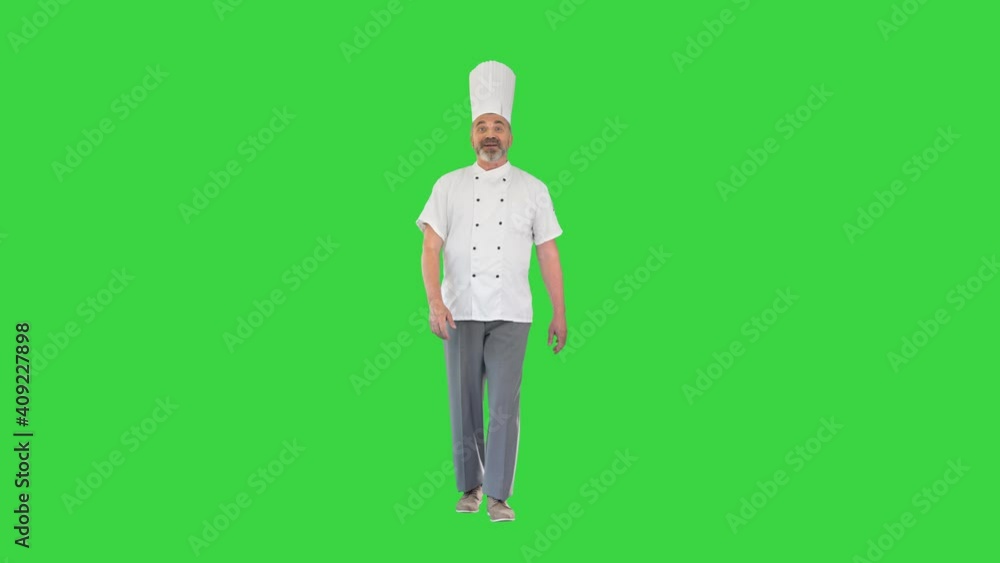 Chef explaining something to camera while walking on a Green Screen, Chroma Key. Chef explaining something to camera while walking on a Green Screen, Chroma Key.