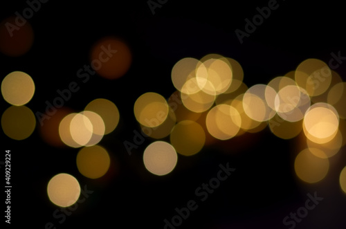 blurry yellow round lights on a dark background