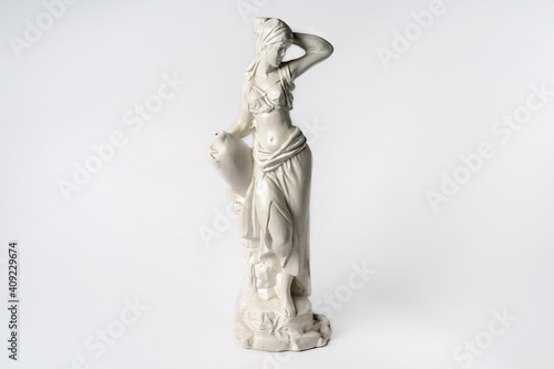 White tabletop ancient statue of a woman on a white isolated background