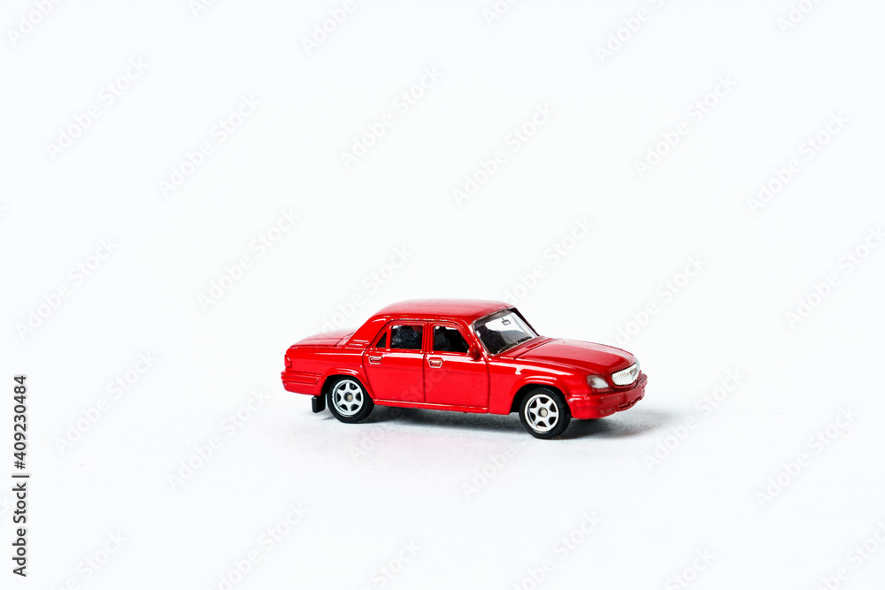 Red toy car on white isolated background